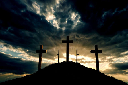 Crosses silhouettes at sunset with dramatic sky. Crosses on the hill.