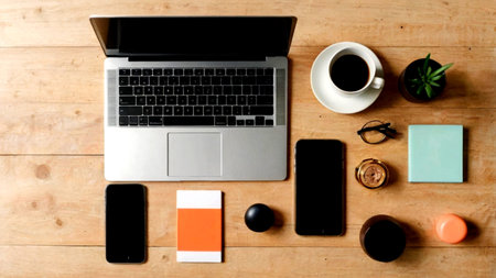 Office desk table with laptop, smartphone, coffee cup and other supplies