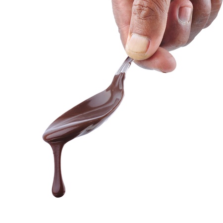 chocolate melting from a spoon isolated on white backgroundの写真素材