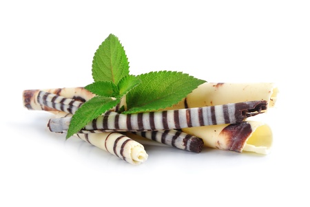 white chocolate curls and green leaf on white backgroundの写真素材