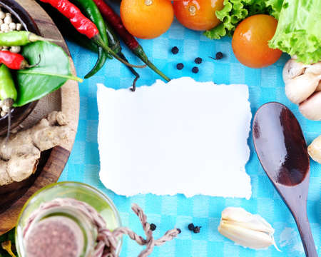 Tomatos, chives, garlic, red chili, ginger, paper and pepper on white background  with sample text の写真素材