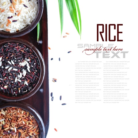Bowls of uncooked rice over white with sample textの写真素材