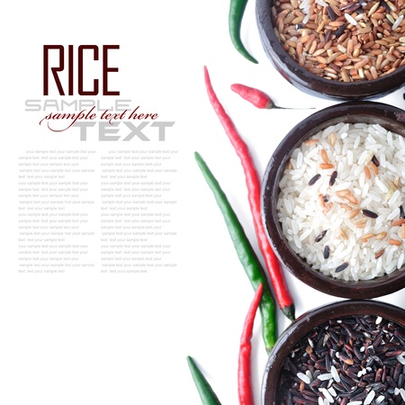 Bowls of uncooked rice over white with sample textの写真素材