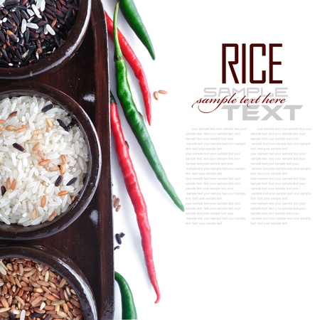 Bowls of uncooked rice over white with sample textの写真素材