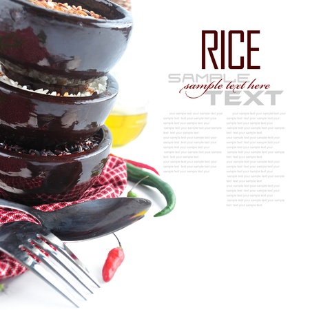 Bowls of uncooked rice over white with sample textの写真素材