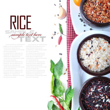 Bowls of uncooked rice over white with sample textの写真素材