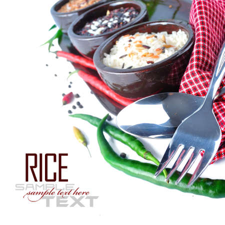 Bowls of uncooked rice over white with sample textの写真素材