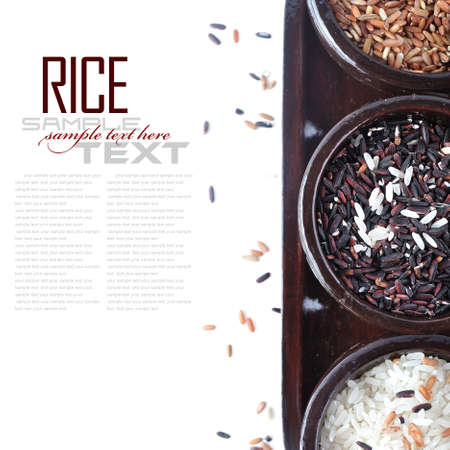 Bowls of uncooked rice over white with sample textの写真素材