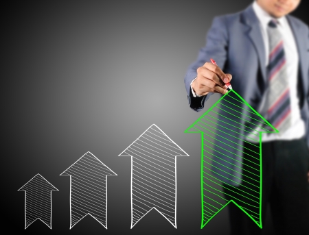 Business man drawing increase arrow の写真素材