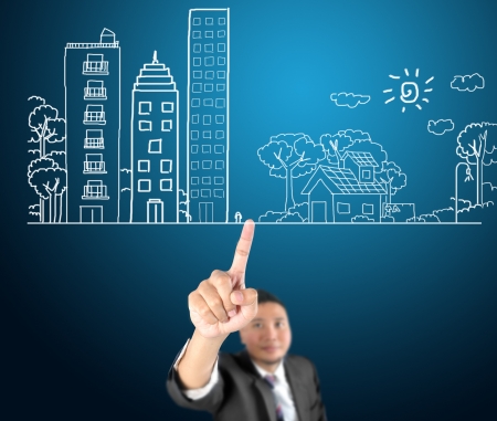 Business man touching of city balance with greenの写真素材
