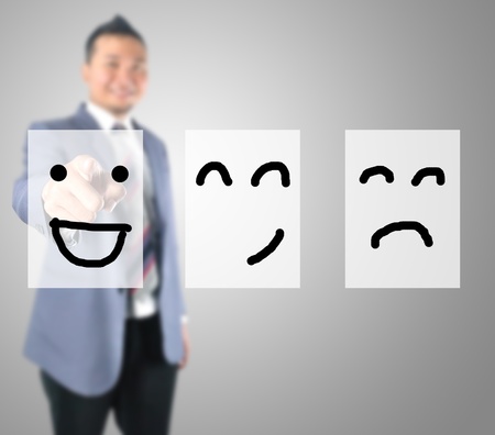 Business man touching emoticonの写真素材