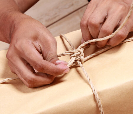 hand binding a ribbon in a giftの写真素材