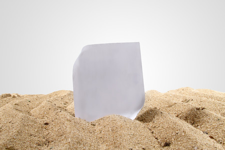 beach sand with a piece of paper isolated on whiteの写真素材