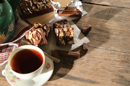 abstract topping chocolate brownies sliced cake with black tea and chocolate bar