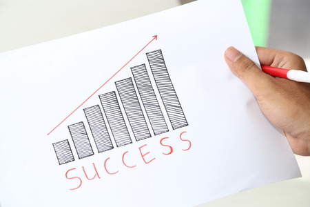 hand holding business success graphの写真素材