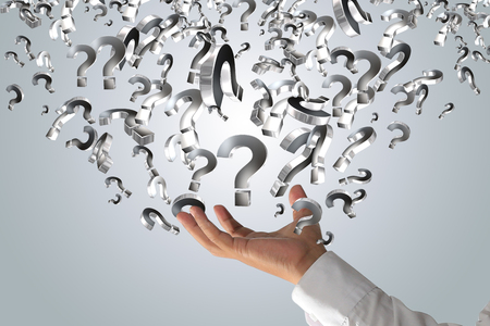 business man holding question marksの写真素材