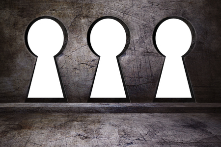 Three keyholes on concreted wallの写真素材