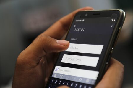 attractive hands writing sign username on a smart phoneの写真素材