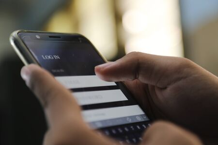attractive hands writing sign username on a smart phone