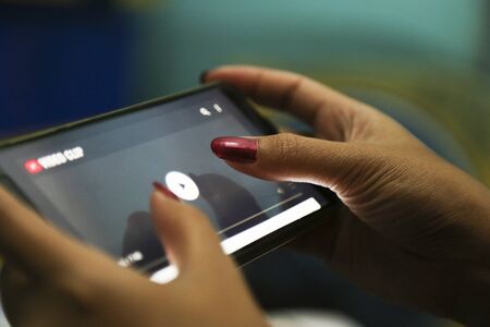 hands playing video on a smart phone