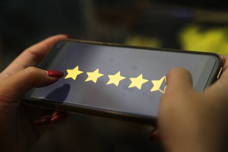 hands showing four point five stars on a smart phone