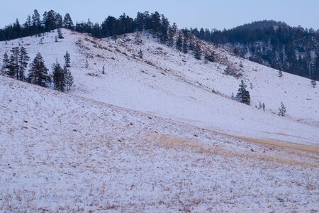 View of snow-covered mountains on a cold dayの写真素材