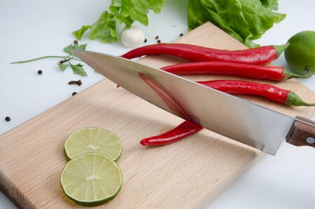 Pepper is reflected from the knife, wooden board, lettuceの写真素材