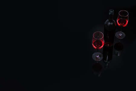 Red wine in glass on black backgroundの写真素材