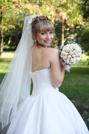 bride with  wedding bouquet In park の写真素材