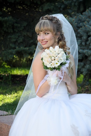 bride with  wedding bouquet In park の写真素材