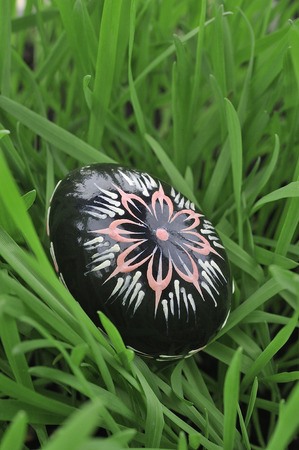 Colorful painted easter egg in the grassの写真素材