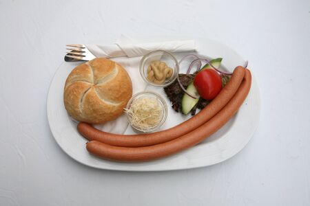 Vienna sausages with bread and salad on a white backgroundの写真素材
