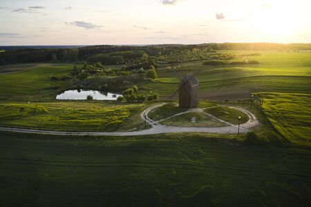 Beautiful sunset above the old windmill on the field. Old mill in Poland photographed from the air,...