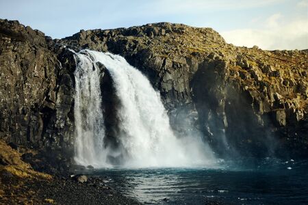 Wild waterfall in Iceland. Waterfall in the light of the setting sun, wild nature. nobody around. Selective focusの写真素材