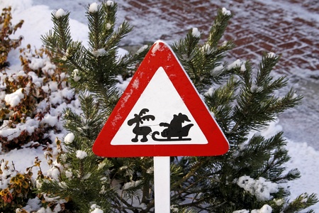 Road sign with Santa Claus on sledges and reindeer in winterの写真素材