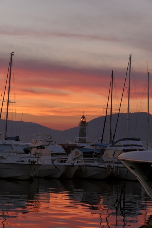 Saint-Tropez, sailing masts with lighthouse in the sunset light, Cote dAzur, French, Riviera, Provence, Southern France, Europeの写真素材
