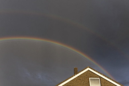 Dark sky with rainbow in Lower Saxony, Germanyの写真素材