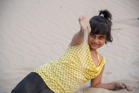 Girl playing in sea beachの写真素材