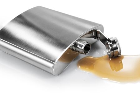 Flask and spilled alcohol on the white background  Isolated の写真素材