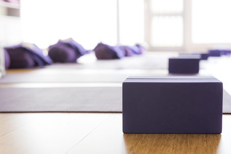 Empty, bright Yoga studio with mats and foam blocks. Wooden floor. Horizontal.の写真素材