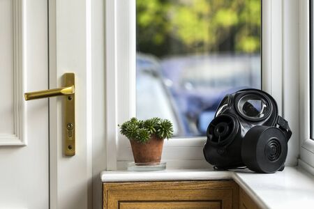 SAS gas mask by the entry door, on the windowsill. Home isolation.の写真素材