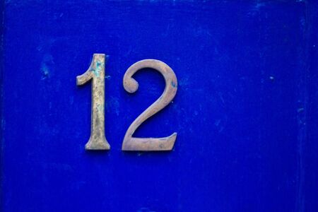 Blue front door with the number 12の写真素材