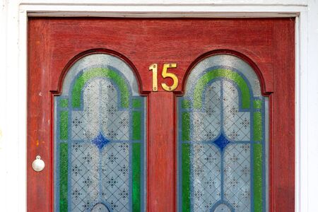 Beautiful door with stained glass and the house number 15の写真素材