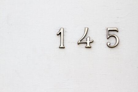 House number 145 on a white wooden front doorの写真素材