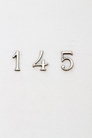 House number 145 on a white wooden front doorの写真素材