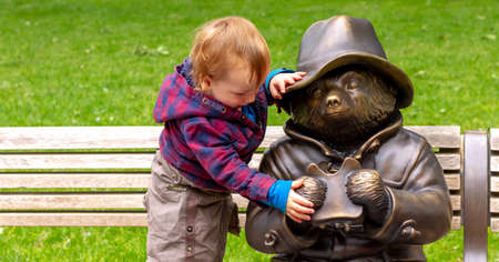 London, Uk, May, 220: During Lockdown in empty Leicester Square a child tries to take a sandwich from Paddington bearのeditorial素材