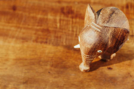 Wooden handmade elephant on a wooden backgroundの写真素材