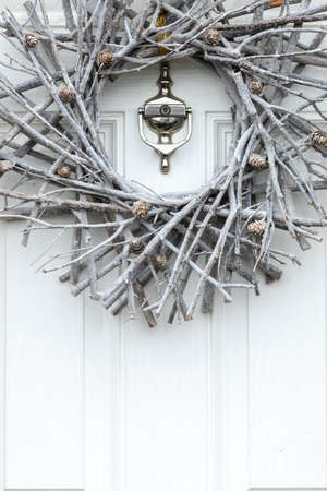 SLeek silver decoration for Christmas on a white wooden front doorの写真素材