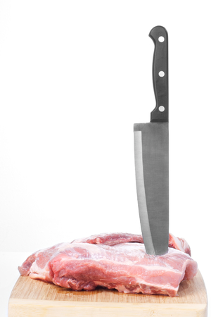 Raw red meat with knife on wooden boardの写真素材