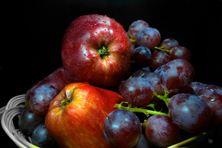 Apples and bunch of graph fruits on blackの写真素材